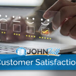 Closeup of a person's hand holding a stylus to complete a customer satisfaction survey