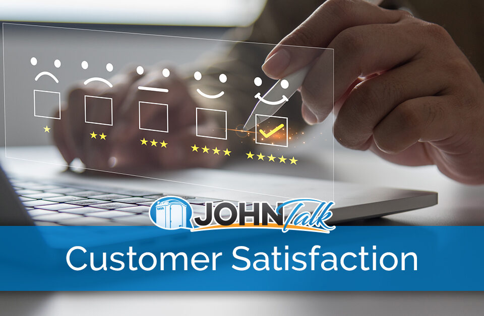 Closeup of a person's hand holding a stylus to complete a customer satisfaction survey