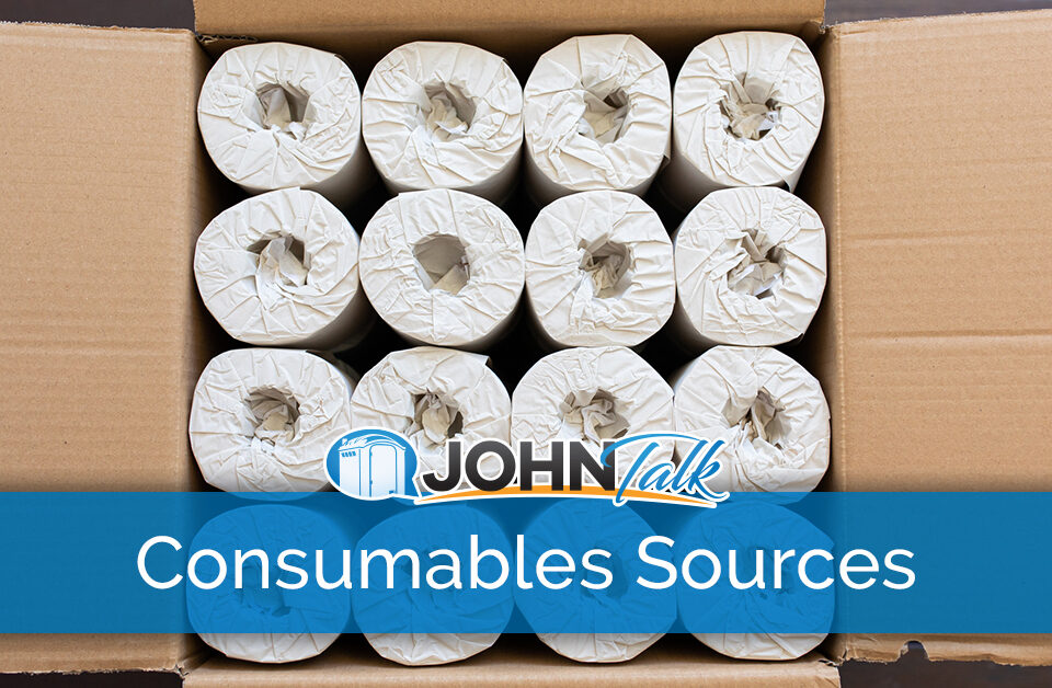 A cardboard box filled with individually wrapped rolls of paper towels