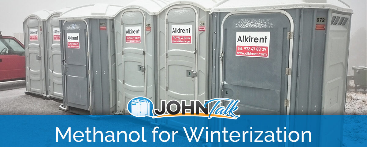 A row of gray portable toilets on a snowy day