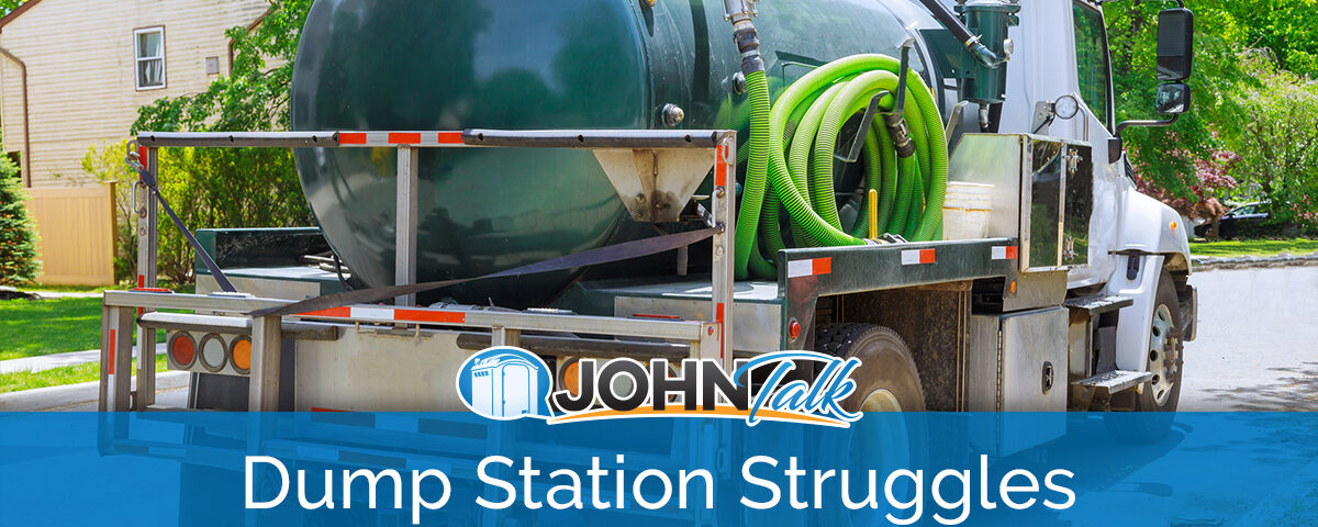 A white truck with a green portable toilet/septic pumping tank and green hose