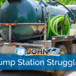 A white truck with a green portable toilet/septic pumping tank and green hose