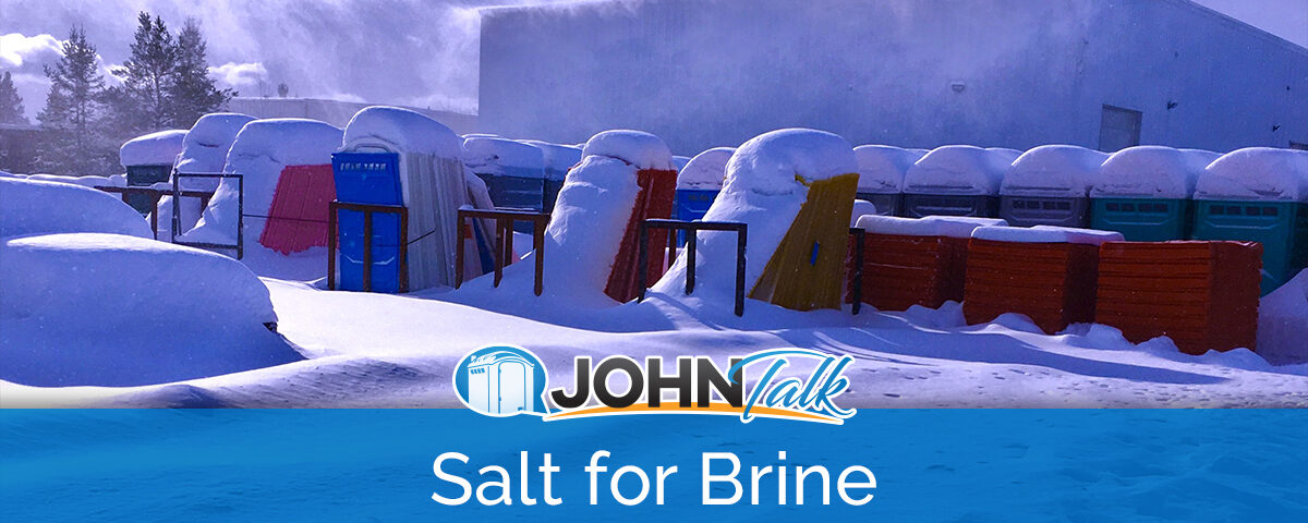 Portable toilets and portable toilet pieces covered in snow