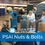 Speakers presenting to tradeshow attendees with portable sanitation products in the background