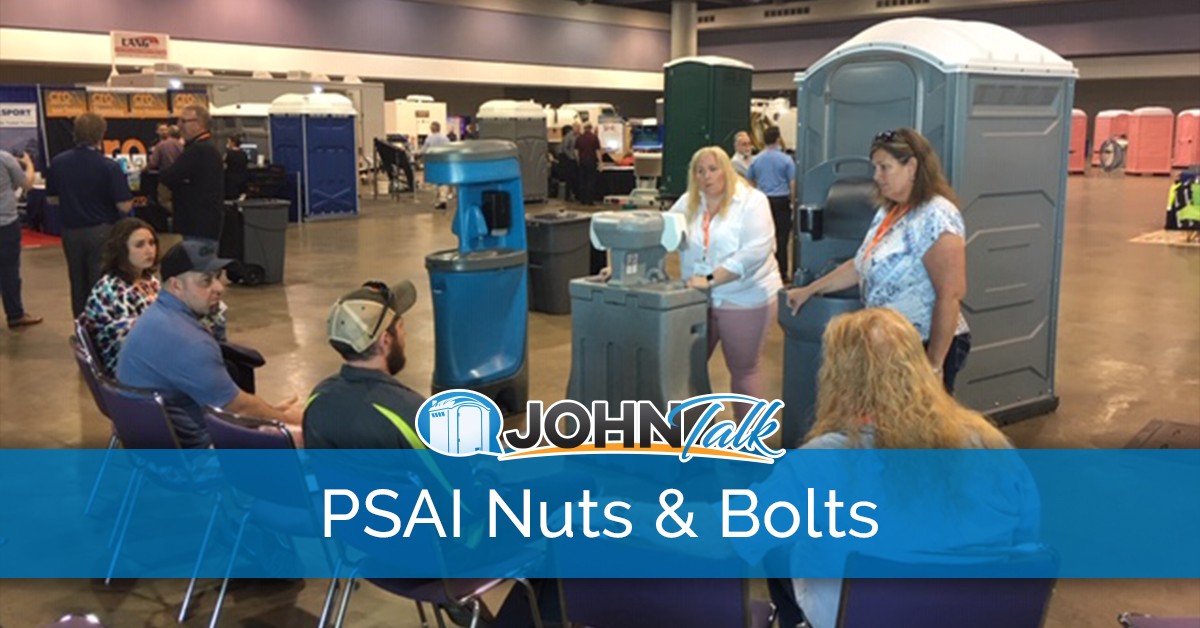Speakers presenting to tradeshow attendees with portable sanitation products in the background