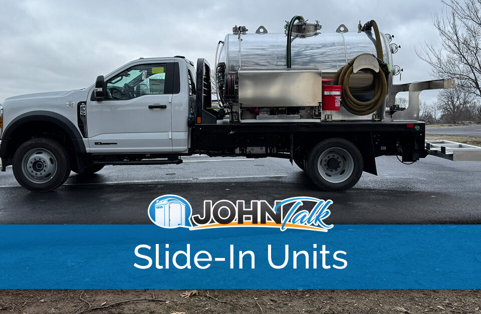 A white truck with a slide-in vacuum pump unit in the back