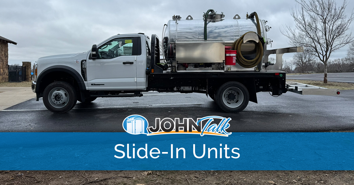 A white truck with a slide-in vacuum pump unit in the back