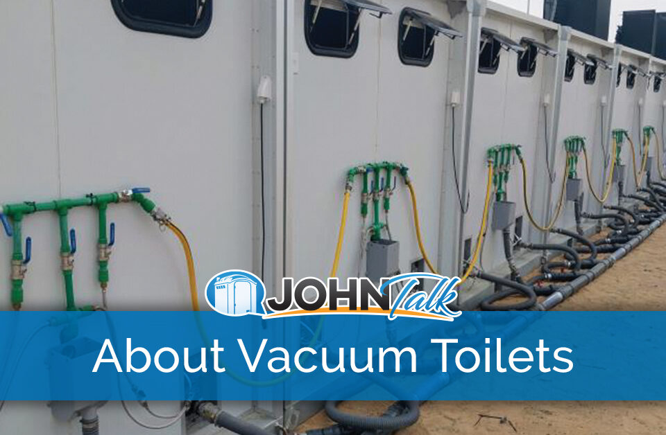 The backs of a row of vacuum toilet systems showing some of the components