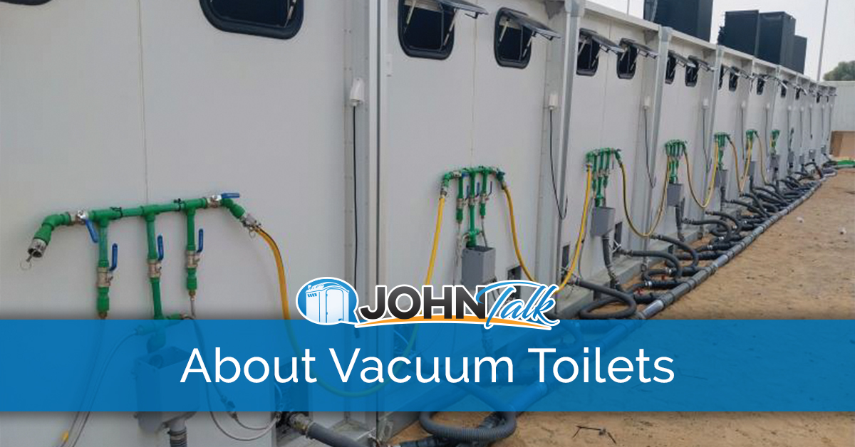 The backs of a row of vacuum toilet systems showing some of the components