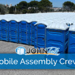 A large group of blue portable toilets