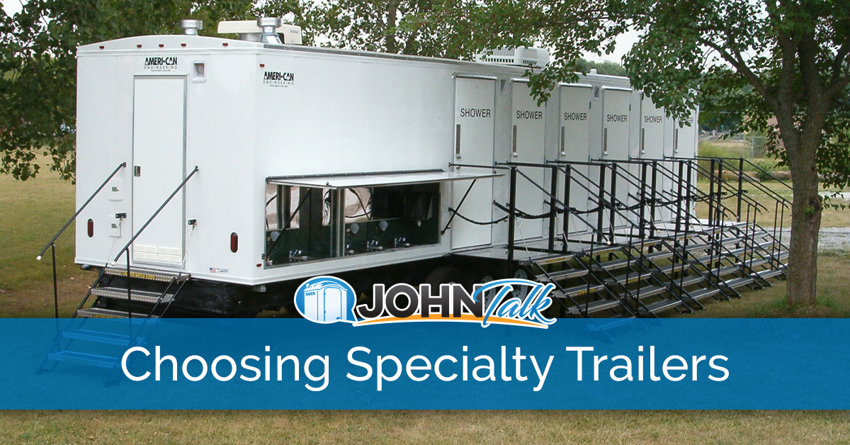 A large, white portable shower trailer
